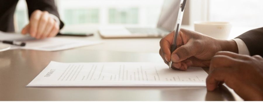 hands signing a contract